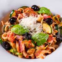 Ribbon Pasta with zucchini and olives in tomato sauce