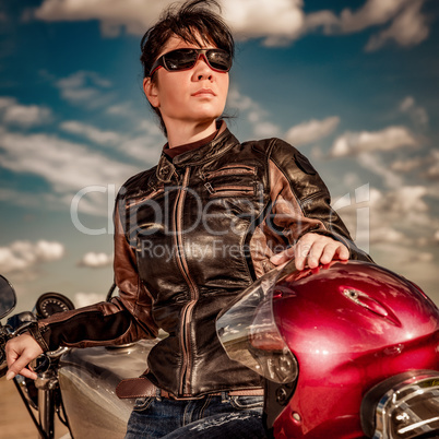 Biker girl sitting on motorcycle