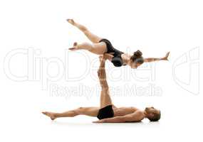 Studio photo of couple practising acrobatics