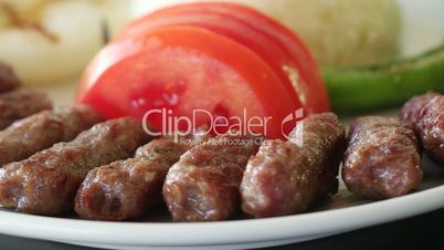 Turkish meatball inegol kofte with rice, onion, tomatoes and green pepper. Rotating shot. Slow motion and close up. Seamless looping.