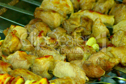 appetizing pieces of fried meat on the fire
