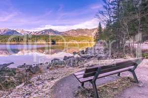 Bench on the shore of an alpine lake