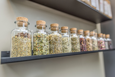 Bottles with tea ingredients on shelf