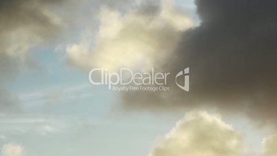 Time lapse of yellow clouds with blue sky