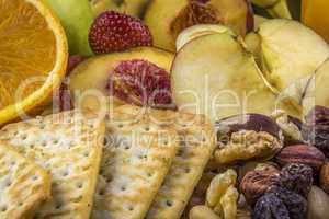 Snacks background, fruits, nuts, crackers