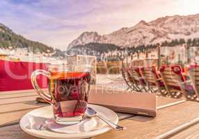 Warm drink and restaurant menu on table in alpine decor