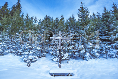 Wooden cross in winter scenery