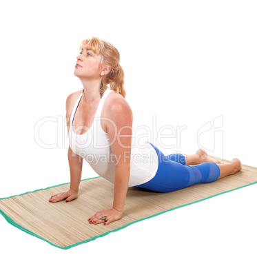 Yoga trainer lying on stomach.