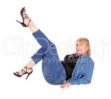 Woman sitting on floor with legs up.