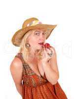 Woman eating strawberry.