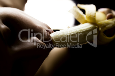 Young beautiful woman in lacy lingerie holding a banana, she is going to eat a banana. she sucks a banana