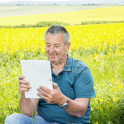 Man with tablet PC on the field