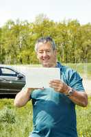 Man with Tablet PC and car
