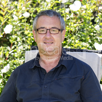 Man sitting on chair in the garden