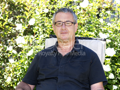 Man sitting on chair in the garden