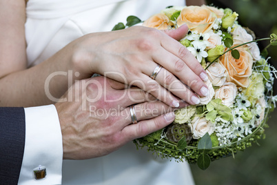 Bridal Bouquet with hands and rings of bridal couple