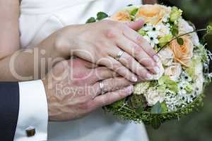 Bridal Bouquet with hands and rings of bridal couple