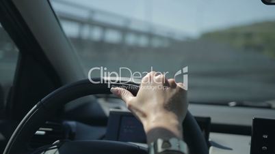 Young woman driving car and making a turn