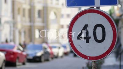 Speed limit sign in the city street on summer day