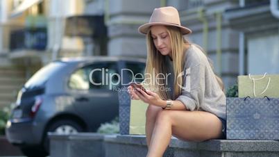 Woman shopping online using mobile phone outdoor