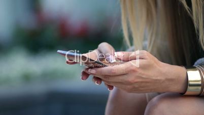woman browsing a mobile phone outdoors