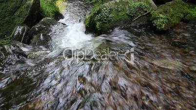Water stream flowing among stones