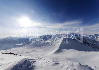 View on off-piste slope and sky with sun