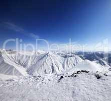 Winter snowy mountains and blue sky