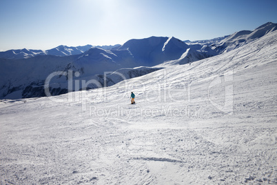 Skier on slope in sun day