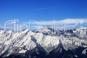 Snowy mountains and blue sky with clouds in nice sunny day