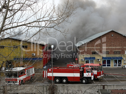 Firefighters extinguish a fire in warehouses