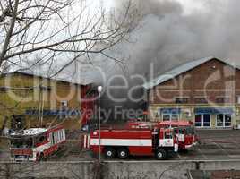 Firefighters extinguish a fire in warehouses