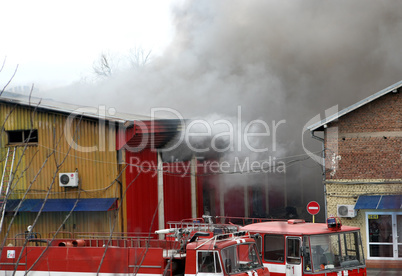 Firefighters extinguish a fire in warehouses