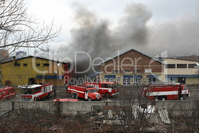 Firefighters extinguish a fire in warehouses