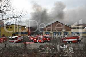 Firefighters extinguish a fire in warehouses