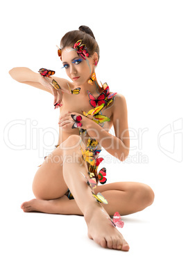 Naked woman posing with butterflies on her body