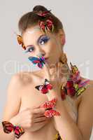 Portrait of beautiful naked girl with butterflies
