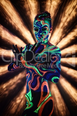 Clubbing. Nude girl poses in ultraviolet light