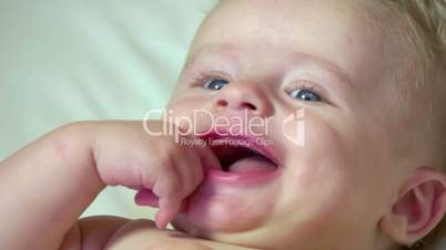 Portrait Of Infant Baby Newborn Child Smiling In Crib Cradle