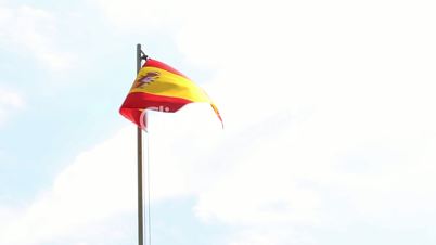 Textile flag of Spain on a flagpole