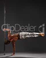 Studio photo of male athlete performing on pylon