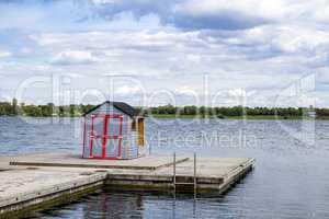 Small house on jetty in the lake