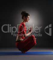 Yoga in studio. Girl doing asana, on gray backdrop