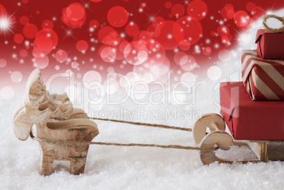 Reindeer With Sled, Christmassy Bokeh And Stars Background, Copy Space