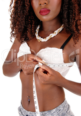 Black woman measuring breast's.