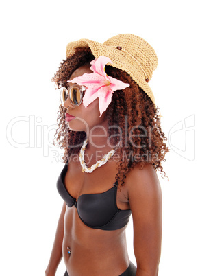 A black woman in bra and straw hat.