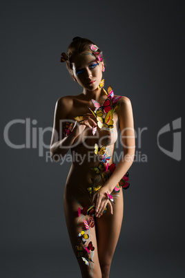 Nude girl poses with body decorated butterflies
