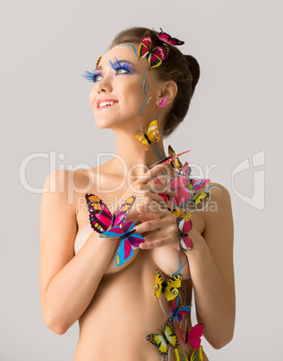 Nude. Amazing girl posing with butterflies on body
