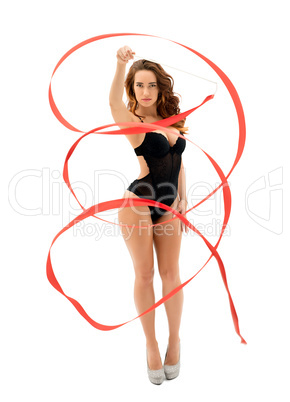 Gorgeous female gymnast dancing with ribbon