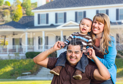 Happy Mixed Race Young Family in Front of House